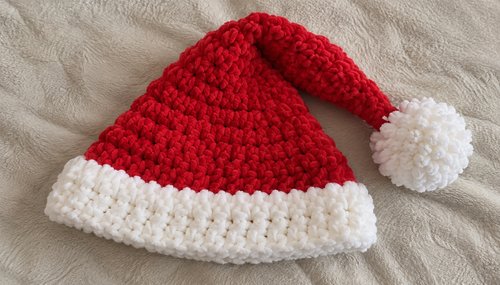 Crochet Santa hat with red body, white ribbed brim and fluffy pom-pom