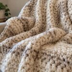 Chunky crochet blanket draped over a chair