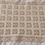 Granny-style baby blanket in soft pink and cream, a free baby blanket crochet pattern easy for beginners