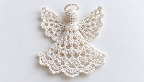 Flat lacy crochet angel ornament showing wings and skirt