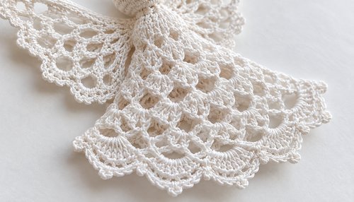 Close-up of shell stitches and picot edge on a crochet angel ornament