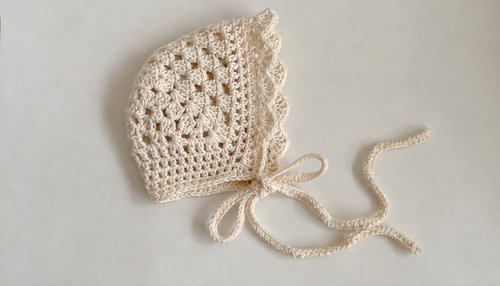Cream vintage crochet baby bonnet with ties