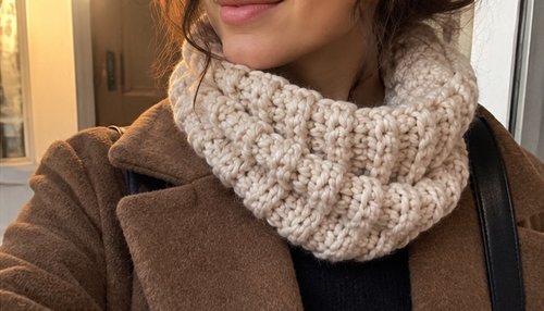 Cozy crochet cowl in worsted yarn with ridged texture, worn looped around the neck