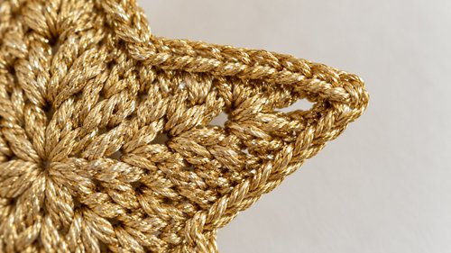 Close-up of crisp star points with corded edge on a crochet star ornament