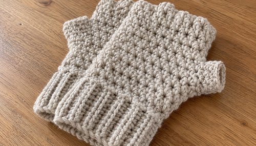 Close-up of crochet fingerless gloves showing stitch and ribbed cuff detail